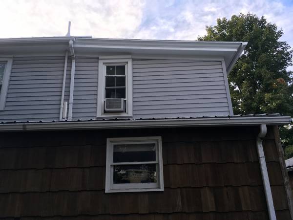 a residential home with newly installed gutters following a gutter repair call